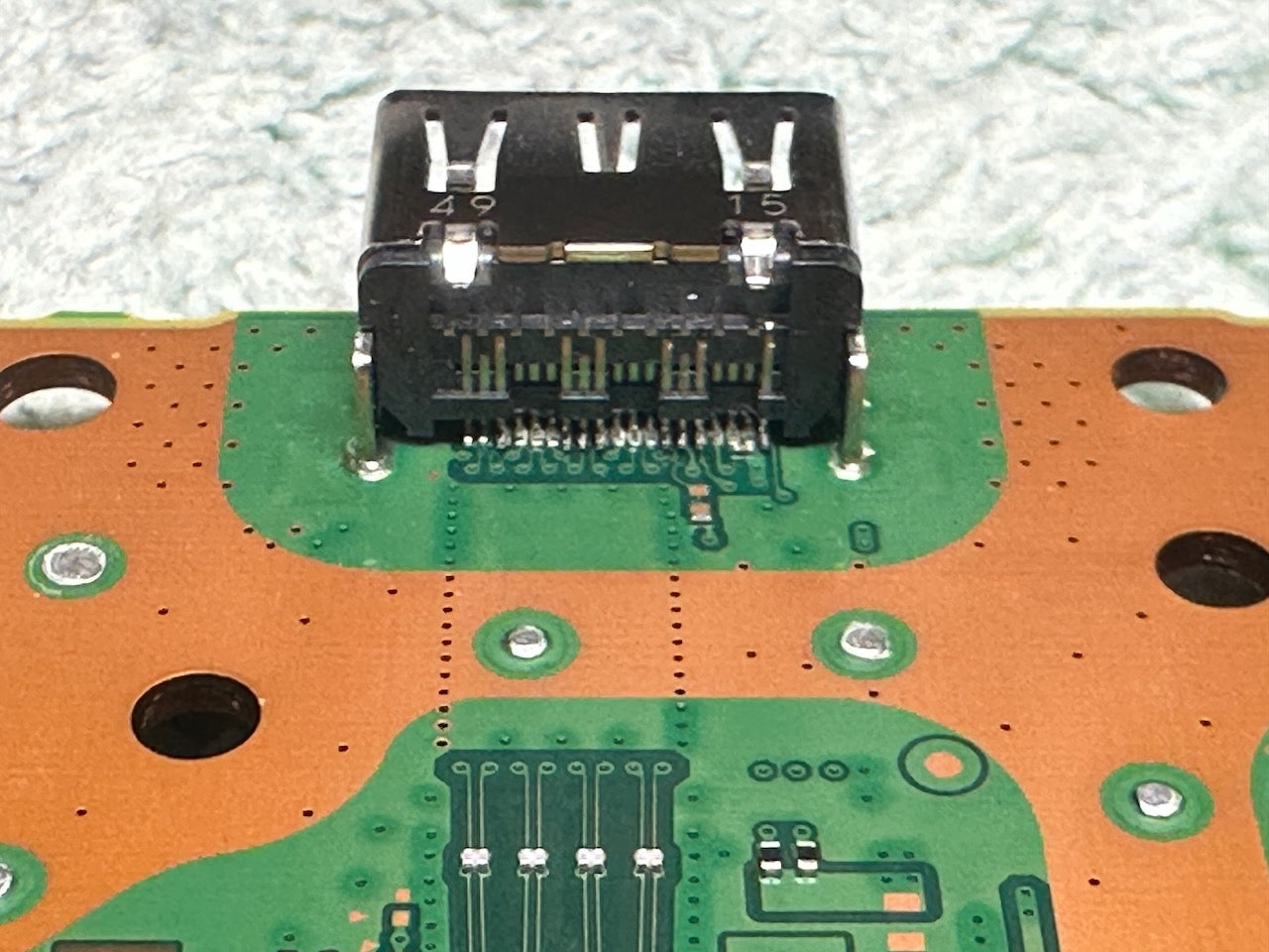 Close-up of a circuit board with electronic components on a white background